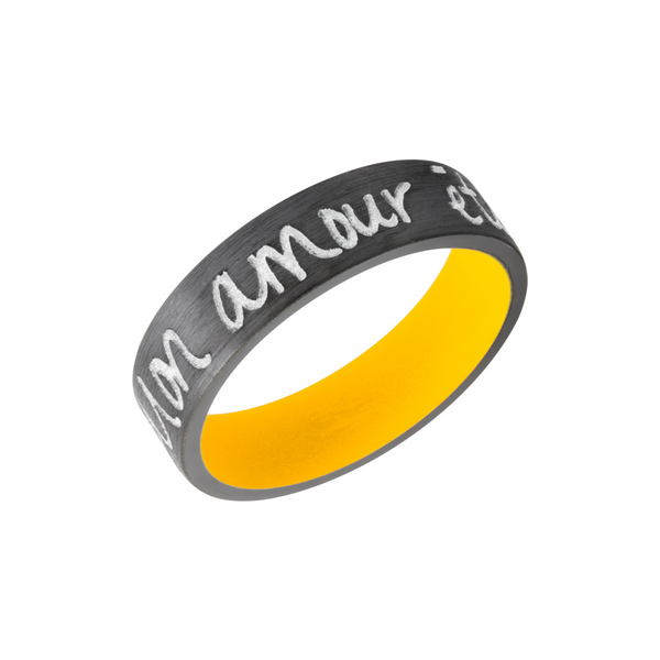 Zirconium 7mm flat band with slightly rounded edges and a laser-carved handwritten message with a yellow Cerakote sleeve Toner Jewelers Overland Park, KS